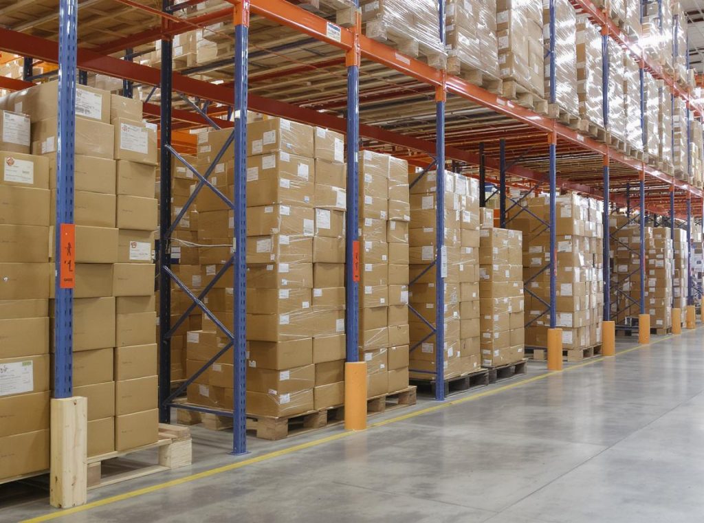 Corrugated boxes properly positioned flat on wooden pallets elevated above warehouse floor