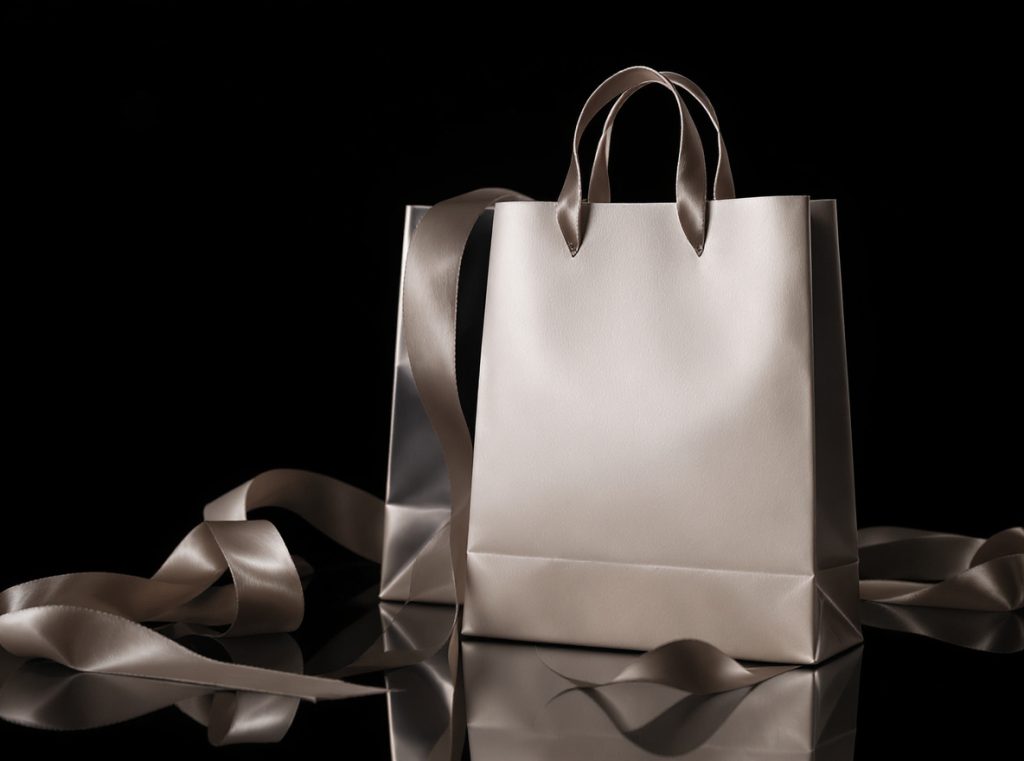 Natural cotton handles on eco-friendly paper shopping bags emphasizing sustainability